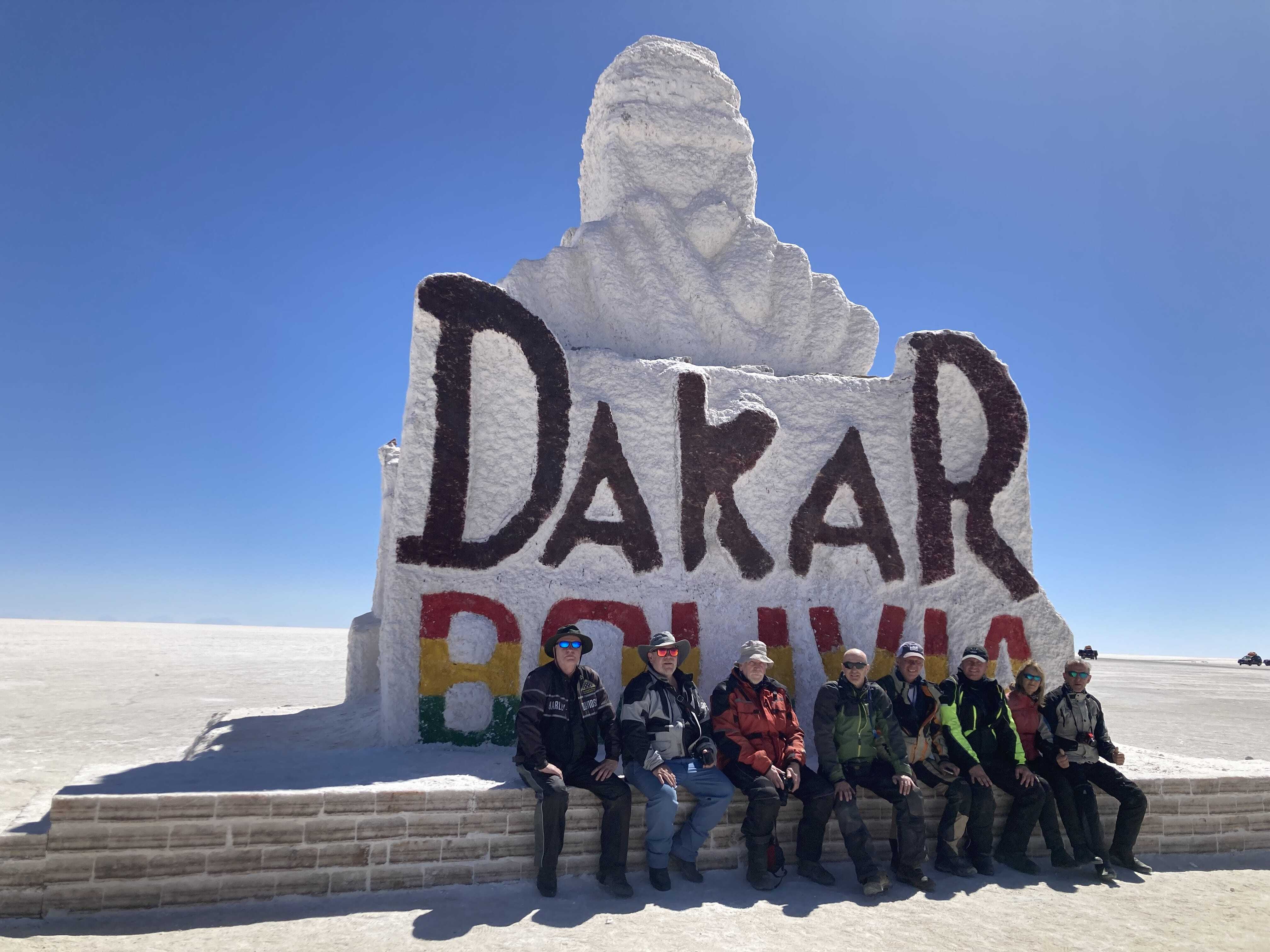 ADV riders in front of Dakar Bolivia Sign near salt desert