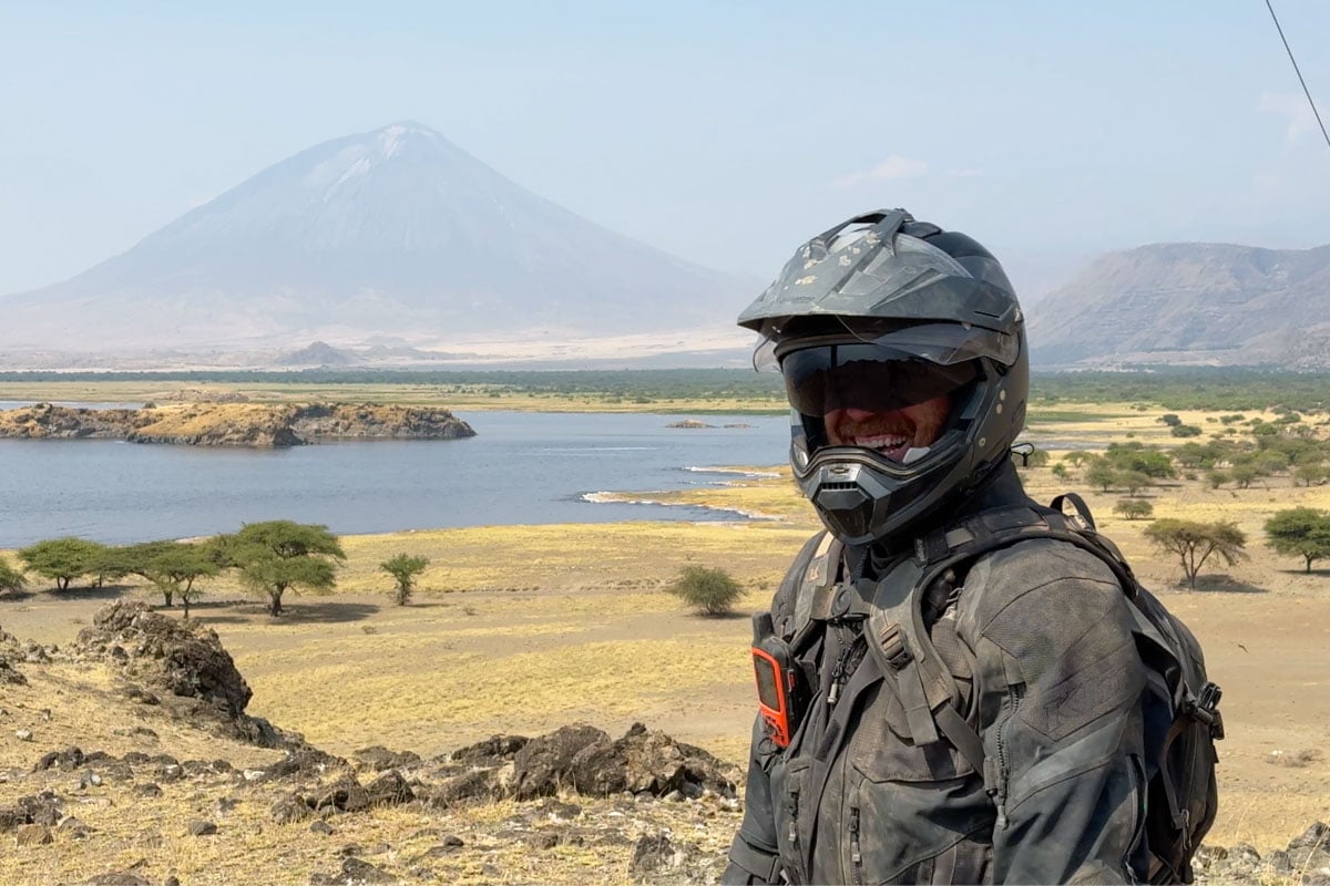 charlie-smiling-with-views-of-lengai-stratovolcano-motorcycle-safari-tanzania-africa