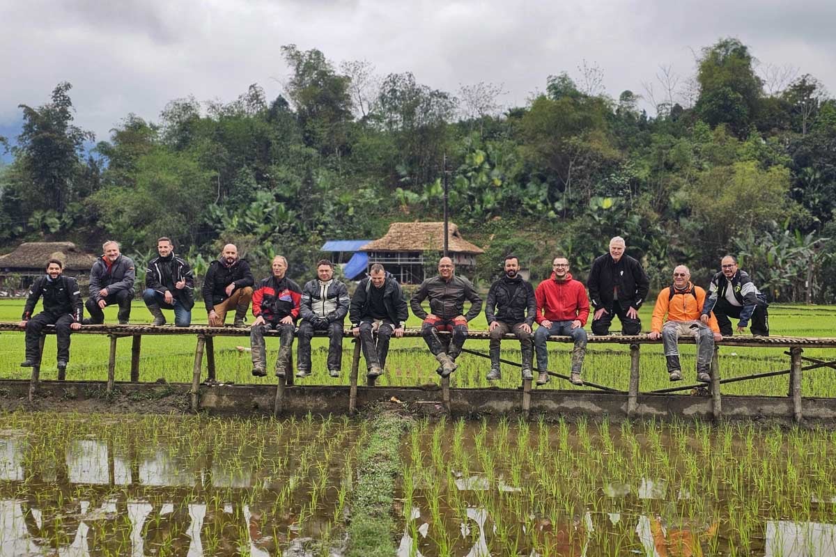 riders-posing-on-bamboo-bridge-rice-field-vietnam